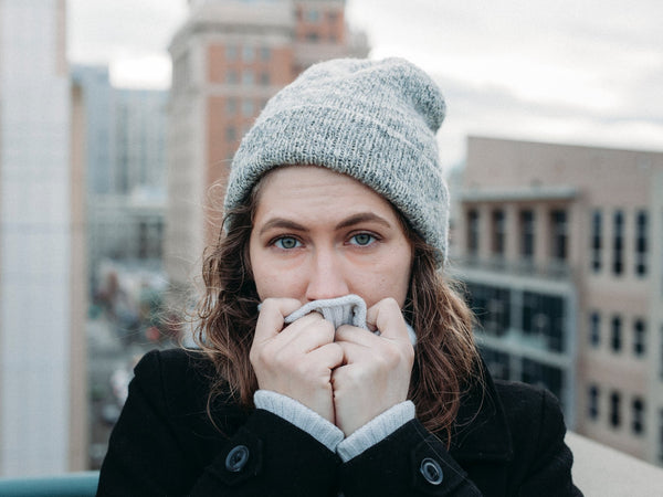 winter time woman covering mouth